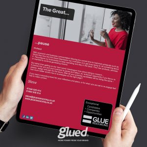 A person holds a tablet showing an email titled The Great... Pause from Steve at Glued Limited, a branding agency in Warwickshire. The message talks about taking a pause in turbulent times. The tablet reveals contact details, reflecting the professionalism of Glueds communications.