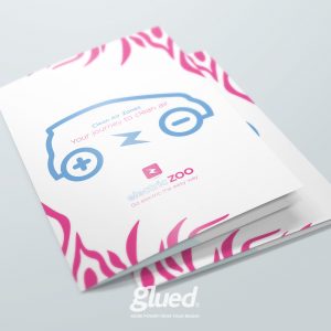 A brochure cover featuring a blue car icon and the text Clean Air Zones: Your journey to clean air and electric ZOO: Go electric the easy way. Pink zebra-like stripes decorate the edges. At the bottom, discover how Glued marketing boosts power with Branding agency Warwickshire expertise.