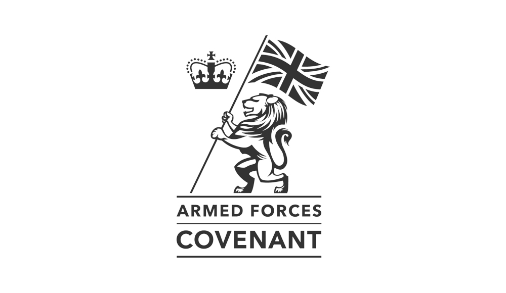 The logo, crafted with a touch of elegance, features a lion proudly holding a British flag, crowned above. Beneath, Armed Forces Covenant is inscribed. Presented in black and white on a plain backdrop, this design showcases the refined expertise akin to Glued Marketing agency Warwickshire.